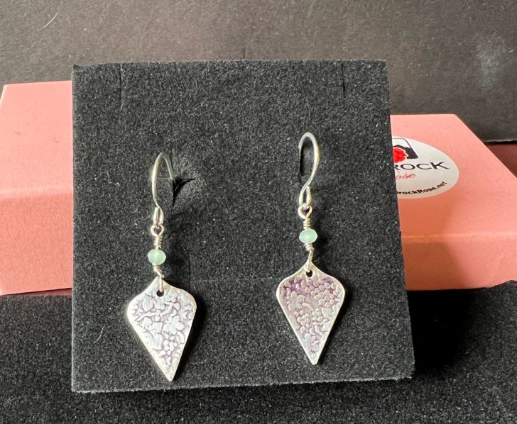 Silver earrings with floral motif by Laura Hingley of Bedrockrose.net